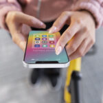 close-up-hands-holding-phone-with-apps