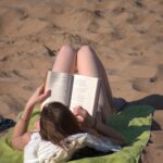 high-angle-view-woman-lying-sand